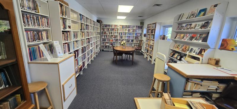 The chapel's lending library, with shelves of books, movies and music and a reading table
