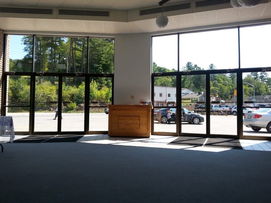 The sunlit lobby of Bancroft Bible Chapel, with glass front doors looking out to Hastings Street